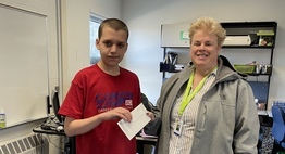 student presents a check to child advocacy center