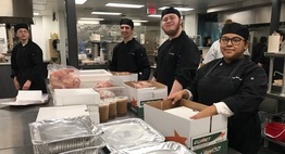 students boxing up dinners