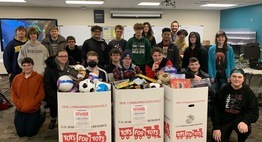 students with boxes of toys to donate