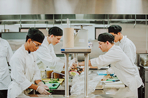 group of students chopping vegetables