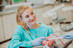 dental student works with dental instruments on a mannequin