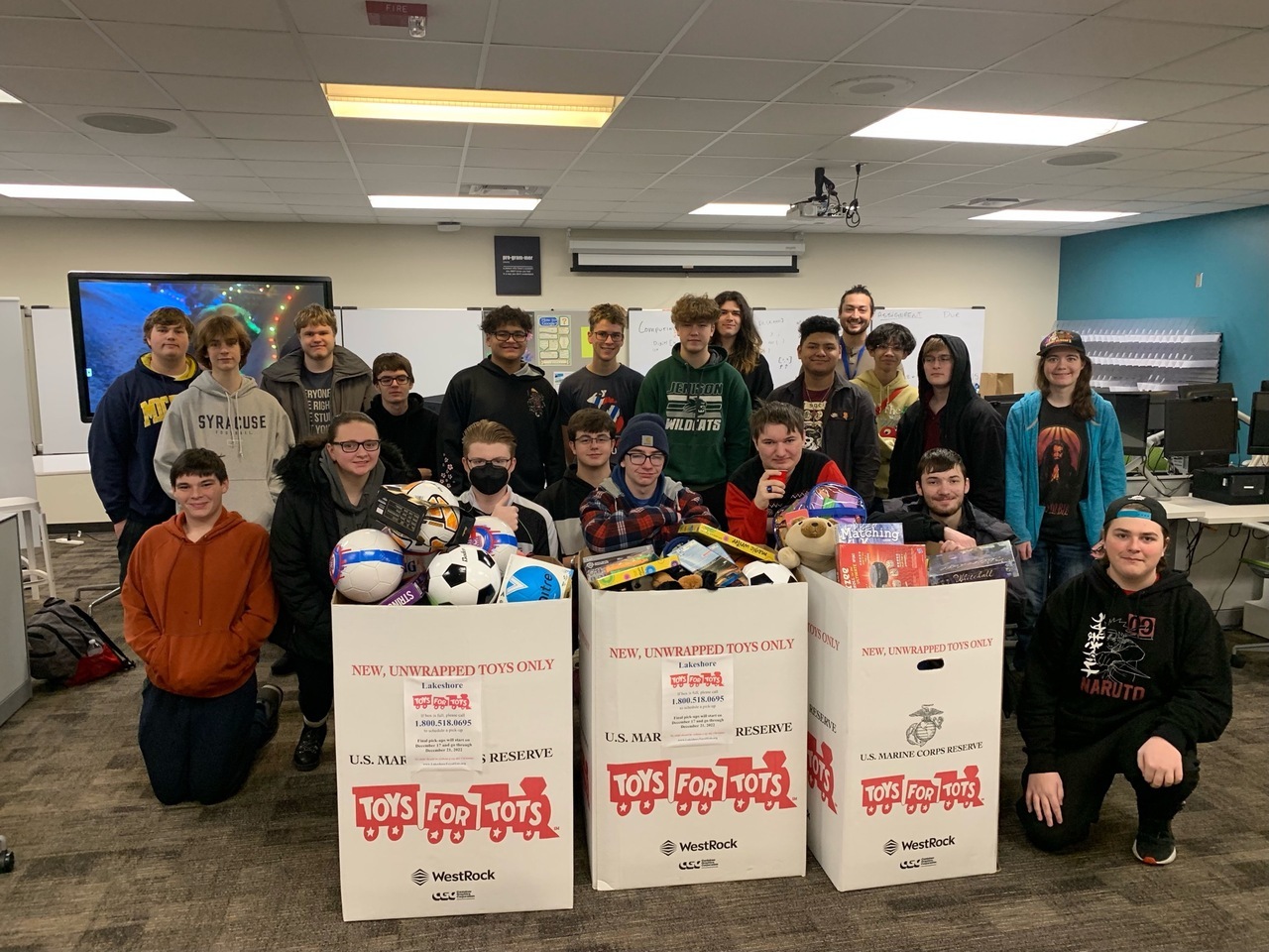 class with boxes of toys to donate